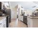 Bright kitchen features granite countertops, stainless appliances, and tiled floors at 17150 Sarong Ln, Punta Gorda, FL 33955