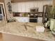 Granite countertops and stylish white cabinetry, creating an inviting space at 17150 Sarong Ln, Punta Gorda, FL 33955