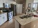Well-equipped kitchen featuring stainless steel appliances, granite countertops, and classic white cabinetry at 17150 Sarong Ln, Punta Gorda, FL 33955