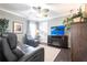 Cozy living room with reclining seating, entertainment center and neutral paint palette at 17150 Sarong Ln, Punta Gorda, FL 33955
