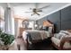 Comfortable main bedroom featuring a decorative wall, ceiling fan and hard wood flooring at 17150 Sarong Ln, Punta Gorda, FL 33955