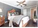 Well-appointed main bedroom with decorative wall, ceiling fan, and hard wood flooring at 17150 Sarong Ln, Punta Gorda, FL 33955
