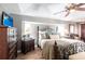 Cozy main bedroom features a decorative bed frame, hardwood floors, and ample natural light at 17150 Sarong Ln, Punta Gorda, FL 33955