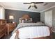 Beautiful main bedroom with an attractive accent wall, ceiling fan, and wood-look flooring at 17150 Sarong Ln, Punta Gorda, FL 33955