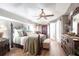Spacious main bedroom with hardwood floors, a ceiling fan, and french doors at 17150 Sarong Ln, Punta Gorda, FL 33955