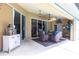 Outdoor patio offering a cozy seating area, ceiling fan, and access to the pool and outdoor space at 17150 Sarong Ln, Punta Gorda, FL 33955