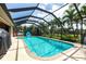 Inviting screened-in pool with ample deck space for lounging, surrounded by lush landscaping and serene water views at 17150 Sarong Ln, Punta Gorda, FL 33955