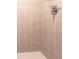 Close up of the tan tiled shower with chrome fixtures, ready to be enjoyed at 17150 Sarong Ln, Punta Gorda, FL 33955