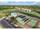 Aerial of a community featuring a pool, tennis courts, shuffleboard, parking, and attractive water features at 175 Kings Hwy # 625, Punta Gorda, FL 33983
