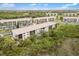 An aerial view of the apartment complex shows multiple buildings near the lake and ample parking at 175 Kings Hwy # 625, Punta Gorda, FL 33983