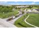 Aerial view of the community entrance with manicured lawns and sign, surrounded by greenery and palm trees at 175 Kings Hwy # 625, Punta Gorda, FL 33983