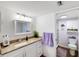Bright bathroom with white vanity, granite countertop, and a stylishly decorated shower at 175 Kings Hwy # 625, Punta Gorda, FL 33983