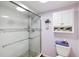 Bright bathroom featuring white cabinets, tiled shower with glass door, and modern fixtures at 175 Kings Hwy # 625, Punta Gorda, FL 33983