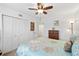Bright bedroom with a floral comforter, ceiling fan, closet and wood dresser with modern decor at 175 Kings Hwy # 625, Punta Gorda, FL 33983