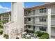 Condo exterior showing a three-story building with well-maintained landscaping and a fresh, clean facade at 175 Kings Hwy # 625, Punta Gorda, FL 33983
