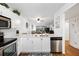 Updated kitchen with white cabinets, stainless steel appliances, and a breakfast bar at 175 Kings Hwy # 625, Punta Gorda, FL 33983