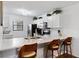 Kitchen with stainless appliances, white cabinets, and a marble countertop breakfast bar with three chairs at 175 Kings Hwy # 625, Punta Gorda, FL 33983