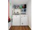 Convenient laundry room features a washer, dryer, and shelving for storage of cleaning supplies at 175 Kings Hwy # 625, Punta Gorda, FL 33983