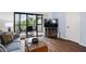 Cozy living room with wood floors, a ceiling fan, and sliding glass doors leading to a balcony at 175 Kings Hwy # 625, Punta Gorda, FL 33983
