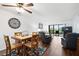 Inviting open-concept living room and dining area with wood floors and sliding glass doors to the lanai at 175 Kings Hwy # 625, Punta Gorda, FL 33983