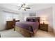 Bright main bedroom featuring ceiling fan, a large window with curtains, and comfortable furniture at 175 Kings Hwy # 625, Punta Gorda, FL 33983