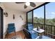 Screened-in patio with tile floor, seating, and a view of palm trees at 175 Kings Hwy # 625, Punta Gorda, FL 33983