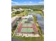 Beautiful aerial shot of the tennis courts and community pool overlooking the lake and surrounding grounds at 175 Kings Hwy # 625, Punta Gorda, FL 33983