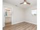 Bedroom with wood-look floors and a view of the attached bathroom, bright and modern at 18178 Wolbrette Cir, Port Charlotte, FL 33948