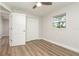 Clean bedroom boasts wood-look floors, closet, and natural light from window at 18178 Wolbrette Cir, Port Charlotte, FL 33948