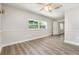 Comfortable bedroom features wood-look floors, natural light, and neutral paint at 18178 Wolbrette Cir, Port Charlotte, FL 33948
