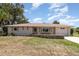 Charming single-story home with a well-maintained lawn and rock border under a blue sky at 18178 Wolbrette Cir, Port Charlotte, FL 33948