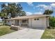 Well-maintained single-story home with a large driveway and attached garage on a sunny day at 18178 Wolbrette Cir, Port Charlotte, FL 33948