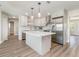 Modern kitchen featuring stainless appliances, an island, and stylish pendant lighting at 18178 Wolbrette Cir, Port Charlotte, FL 33948
