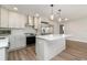 Modern kitchen featuring stainless appliances, an island, and stylish pendant lighting at 18178 Wolbrette Cir, Port Charlotte, FL 33948