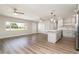 Spacious and bright living room with hardwood floors, modern kitchen, and backyard views at 18178 Wolbrette Cir, Port Charlotte, FL 33948