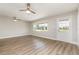 Living room featuring hardwood flooring, natural light, and modern ceiling fans at 18178 Wolbrette Cir, Port Charlotte, FL 33948