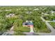 A beautiful home shown from the air, complete with a pool and surrounded by mature, lush landscaping at 2031 Backton St, Port Charlotte, FL 33948