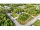 From the air, this home with its own pool shows off it's lovely yard and neighborhood tree canopy at 2031 Backton St, Port Charlotte, FL 33948