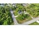 The home's pool, lush landscaping, and nearby trees are on display in this neighborhood aerial view at 2031 Backton St, Port Charlotte, FL 33948