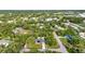 Aerial view of a charming single Gathering home surrounded by lush greenery in a tranquil neighborhood at 2031 Backton St, Port Charlotte, FL 33948
