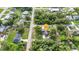 A neighborhood aerial showcasing the home, pool, proximity to amenities, surrounding homes and mature trees at 2031 Backton St, Port Charlotte, FL 33948