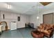 Functional basement space with a washer, dryer, and cozy seating area, ready for customization at 2031 Backton St, Port Charlotte, FL 33948