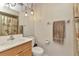 Neutral bathroom featuring a vanity, toilet, and shower/tub combination, all with modern fixtures at 2031 Backton St, Port Charlotte, FL 33948