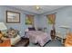 Cozy bedroom with comfortable furnishings, natural light, and a ceiling fan for added comfort at 2031 Backton St, Port Charlotte, FL 33948