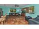 Eat-in dining area with bamboo chairs, an aquarium, and a comfortable couch at 2031 Backton St, Port Charlotte, FL 33948
