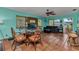 Eat-in kitchen area with dining set, adjacent to a living area with a couch and an aquarium at 2031 Backton St, Port Charlotte, FL 33948
