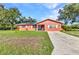 Exterior view of a home with lawn and driveway at 2031 Backton St, Port Charlotte, FL 33948