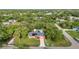 Aerial view of a charming single Gathering home featuring a modern roof, solar panels, and a refreshing backyard pool at 2031 Backton St, Port Charlotte, FL 33948