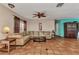 Expansive living room with terracotta tile floors, ample seating, and neutral tones, perfect for relaxation at 2031 Backton St, Port Charlotte, FL 33948
