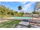 Backyard pool with privacy fence and tropical trees at 2031 Backton St, Port Charlotte, FL 33948